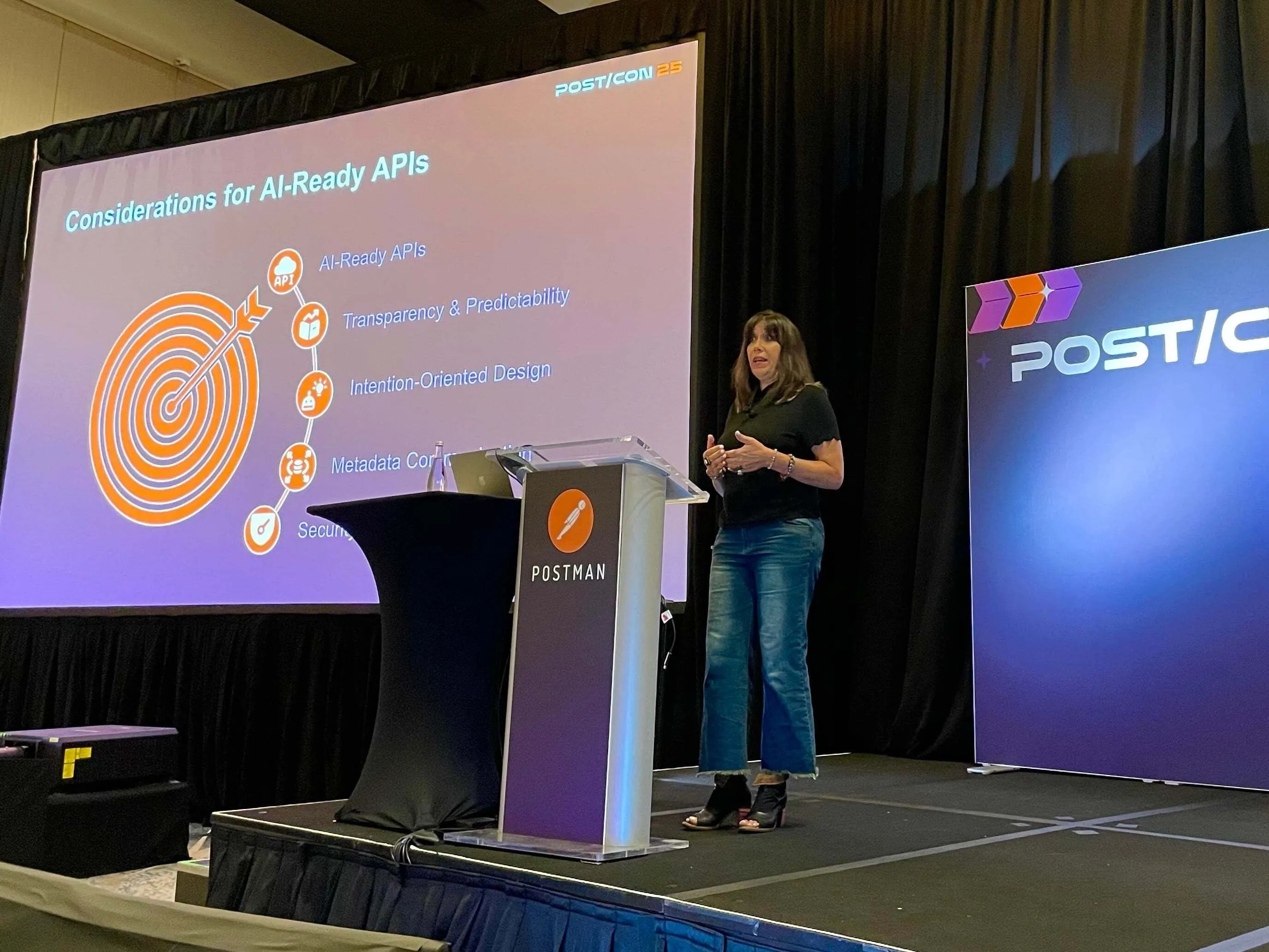 Rebecca from PayPal on stage delivering her paper. The slide behind is titled considerations for AI ready APIs.